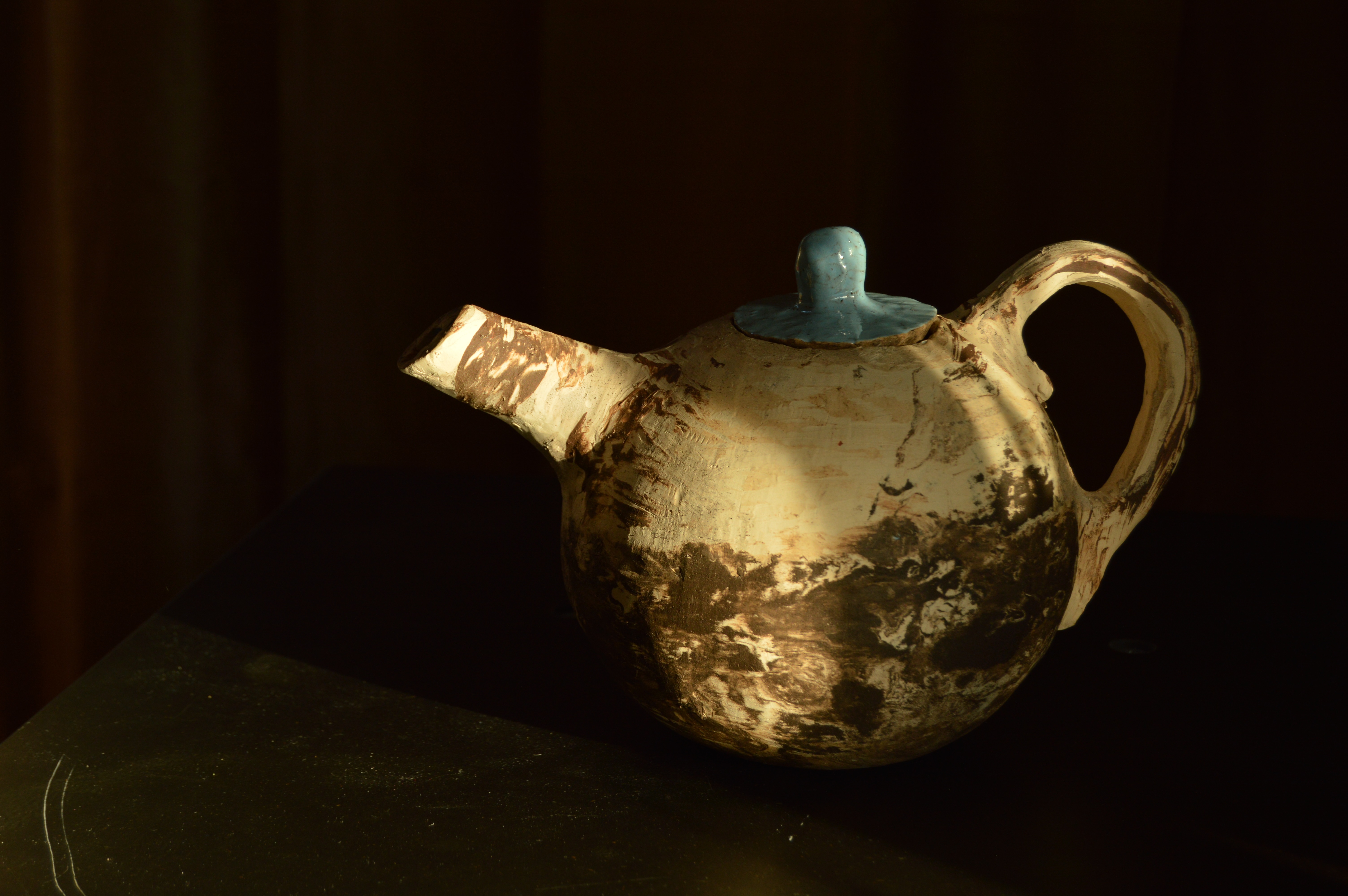 Slabbuilt tea-pot. Clay in different colours. Glazed.